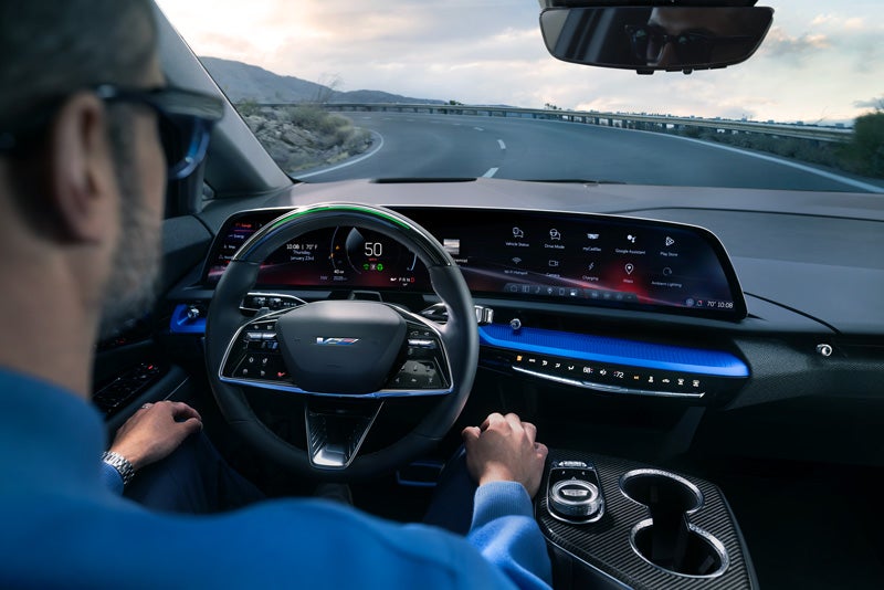 Front View of the 2026 OPTIQ-V Driving Through the Dusk Utilizing its Headlights | Garlyn Shelton Cadillac in Temple TX