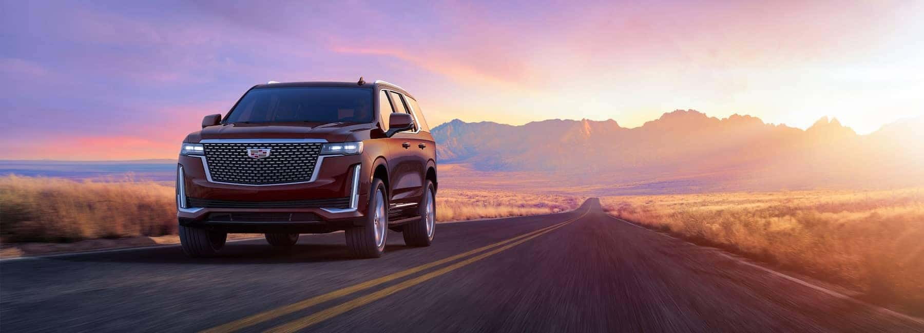 2023 Escalade-V driving down road at sunset
